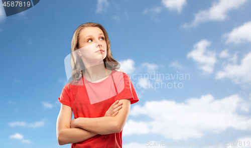 Image of teenage gir with crossed arms over sky