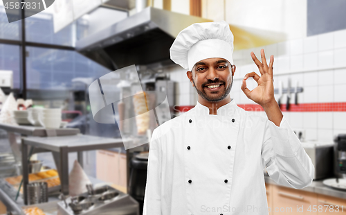 Image of indian chef in toque showing ok at kebab shop