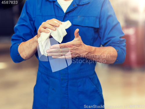 Image of mechanic man or smith with wipe at car workshop
