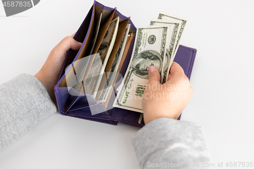 Image of close up of woman hands with wallet and us money