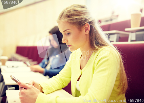 Image of student girls with smartphones on lecture