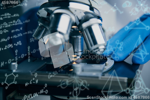 Image of Close-up shot of microscope with metal lens at laboratory.