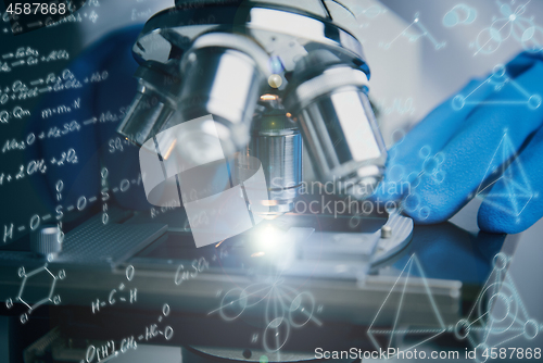 Image of Close-up shot of microscope with metal lens at laboratory.