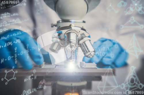 Image of Close-up shot of microscope with metal lens at laboratory.