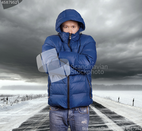 Image of Asian man stand on snow road in winter