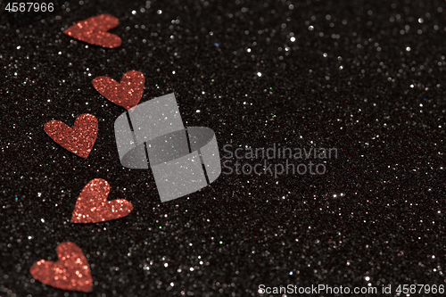 Image of Hearts over black abstract background with bokeh