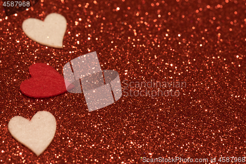 Image of Hearts over red abstract background with bokeh