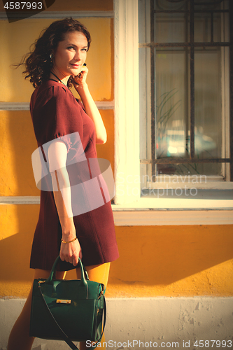 Image of smiling woman in a burgundy dress