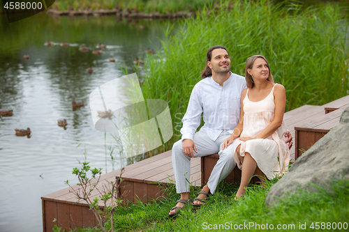 Image of Happy couple resting by the lake