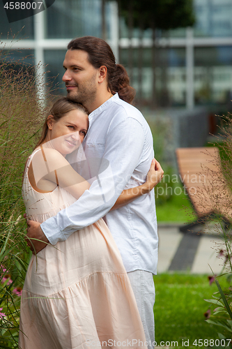 Image of Pregnancy. A young man and a pregnant woman