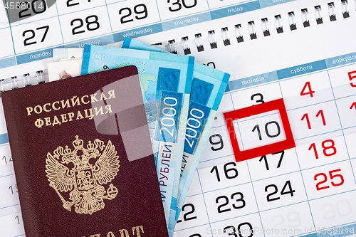 Image of Passport and two 2,000 bills are on the calendar