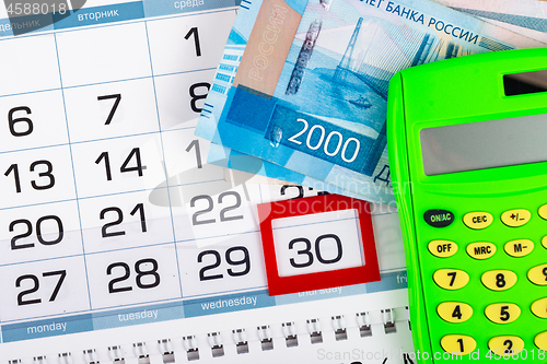 Image of Calendar with a allocated 30 number, Russian two two-thousand bills, calculator