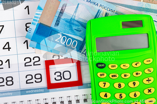 Image of Calendar with a allocated 30 number, Russian two-thousand bills, calculator