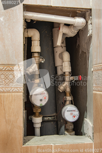 Image of cold and hot water meters embedded in the wall