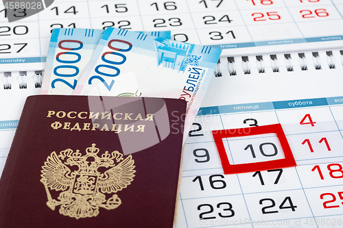 Image of On the calendar with the marked 10 number is a passport and two 