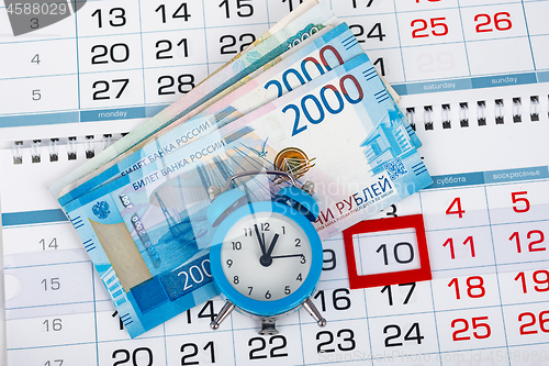 Image of Calendar with a dedicated 10 number, a pack of Russian money and a clock