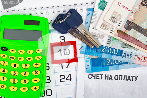 Image of Calendar with the number 10, calendar, calculator, bunch of keys and a pack of Russ rubles, and the invoice