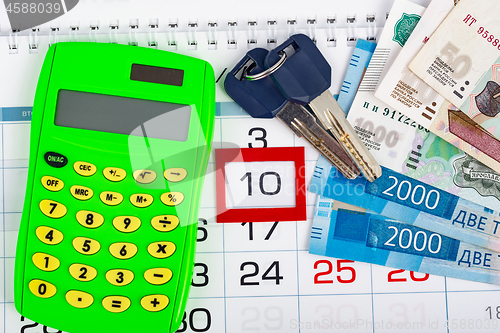 Image of Calendar with the number 10, calendar, calculator, bunch of keys and a pack of Russ rubles