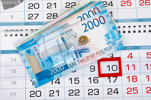 Image of On the calendar with the number 10 is a pack of Russian rubles