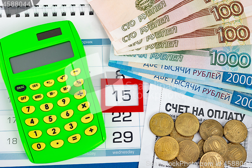 Image of Calendar with a dedicated 15 number, calculator, Russian rubles banknotes and coins