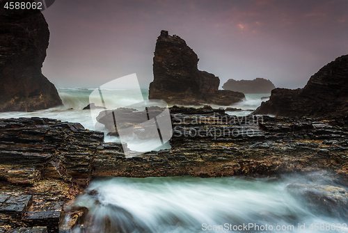 Image of Raging waters over and around jagged craggy coastal rocks