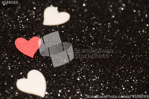 Image of Hearts over black abstract background with bokeh