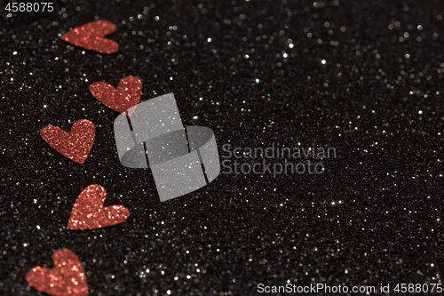 Image of Hearts over black abstract background with bokeh