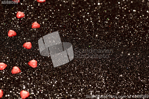 Image of Hearts over black abstract background with bokeh