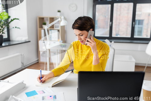 Image of ui designer calling on smartphone at office