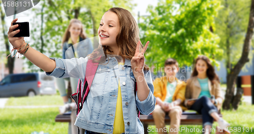 Image of teenage student girl taking selfie by smartphone