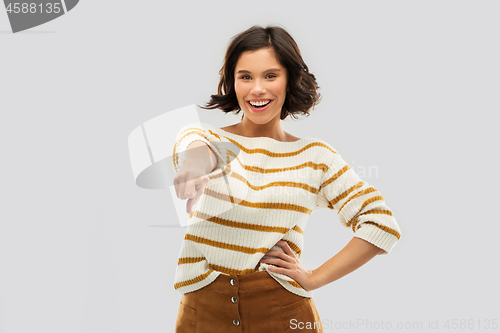 Image of happy smiling woman pointing finger to you