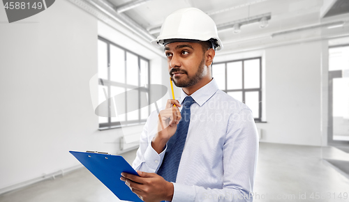 Image of architect or businessman in helmet with clipboard