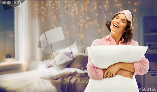 Image of woman with pillow in pajama and eye sleeping mask