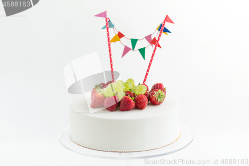 Image of close up of birthday cake with garland on stand