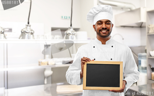 Image of indian chef with chalkboard at restaurant kitchen