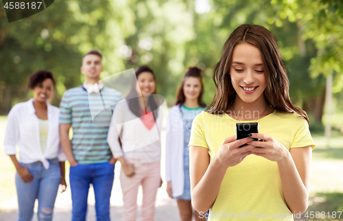 Image of young woman or teenage girl using smartphone