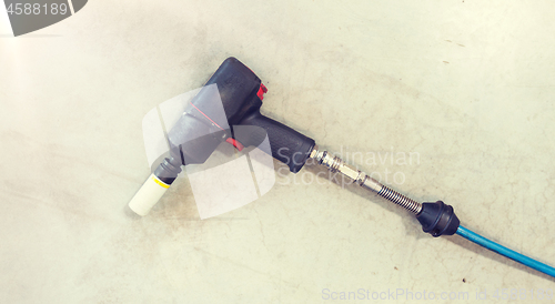 Image of screwdriver on floor at tire shop