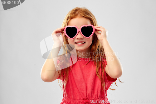 Image of smiling red haired girl in heart shaped sunglasses