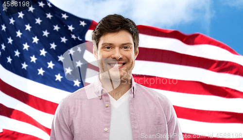 Image of smiling man over flag of united states of america