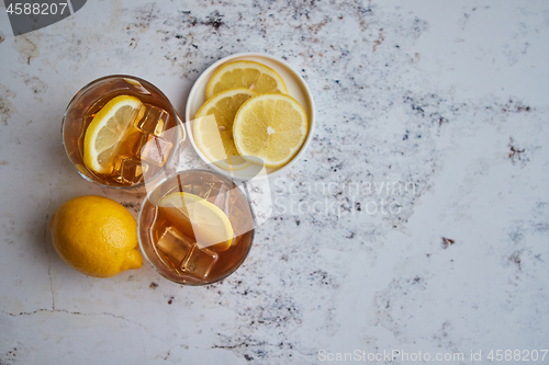 Image of Whiskey sour drink with lemon in glass on stone rustical background