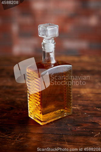 Image of Bottle of whiskey on wooden table