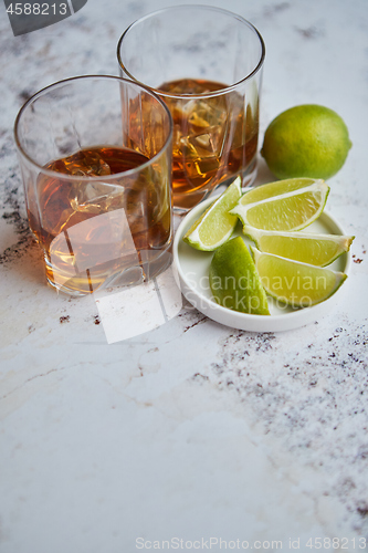 Image of Whiskey sour drink with lemon in glass on stone rustical background