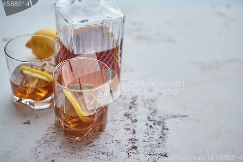 Image of Whiskey sour drink with lemon in glass on stone rustical background