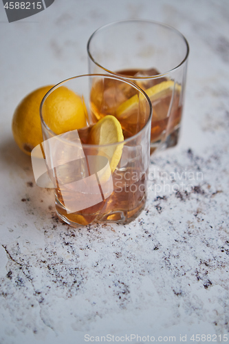 Image of Whiskey sour drink with lemon in glass on stone rustical background