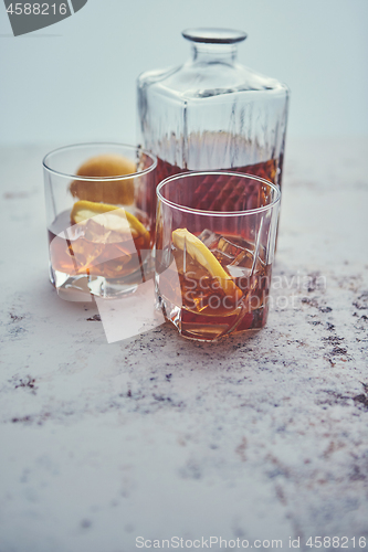 Image of Whiskey sour drink with lemon in glass on stone rustical background