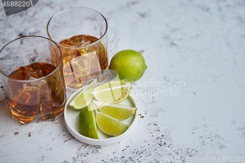 Image of Whiskey sour drink with lemon in glass on stone rustical background