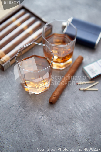 Image of Carafe of Whiskey or brandy, glasses and box of finnest Cuban cigars