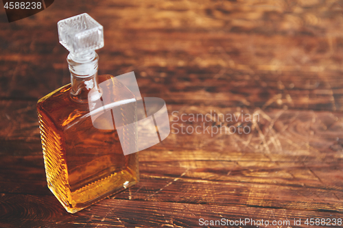 Image of Bottle of whiskey on wooden table