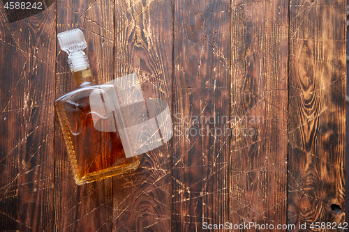 Image of Bottle of whiskey on wooden table