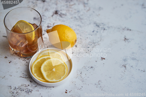 Image of Whiskey sour drink with lemon in glass on stone rustical background
